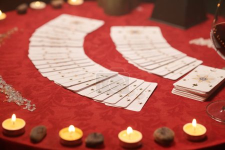 Photo for Tarot cards spread on table covered with red cloth - Royalty Free Image