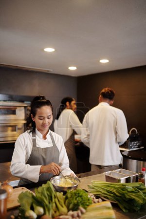 Photo for Team of cooks working in kitchen of modern restaurant - Royalty Free Image