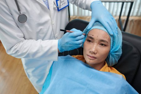 Photo for Young Vietnamese woman getting prepared for facelift surgery - Royalty Free Image