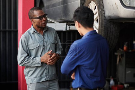 Photo for Auto mechanic talking to client about details that need to be fixed - Royalty Free Image
