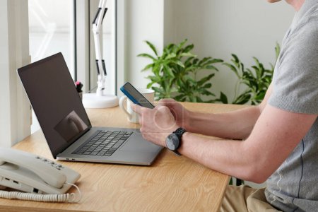 Foto de Imagen de primer plano del hombre revisando correos electrónicos y notificaciones en el teléfono inteligente - Imagen libre de derechos