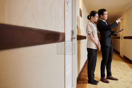Photo for Resort manager explaining maid her job duties - Royalty Free Image