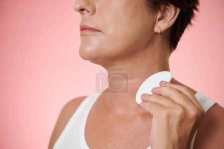 Photo for Cropped image of mature woman massaging neck with gua sha to reduce wrinkles - Royalty Free Image