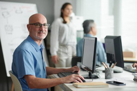 Photo for Portrait of positive mature man attending computer class - Royalty Free Image