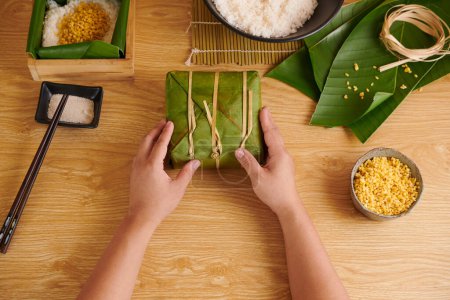 Photo for Process of wrapping Vietnamese square cake in banana leaves - Royalty Free Image