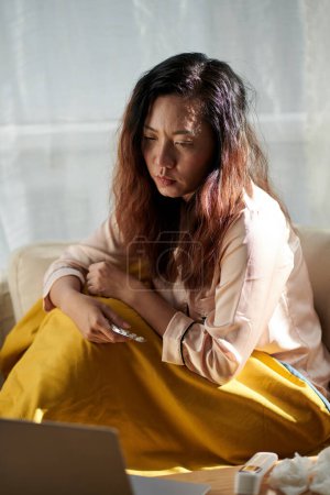 Photo for Sick woman in pajamas is too weak to leave her bed in the morning - Royalty Free Image