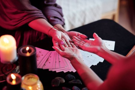 Photo for Fortune teller asking client to give her hands when reading palms - Royalty Free Image