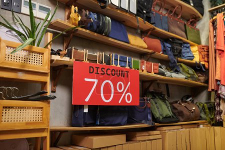 Photo for Sign with seventy percent discount on shelf in thrift shop - Royalty Free Image
