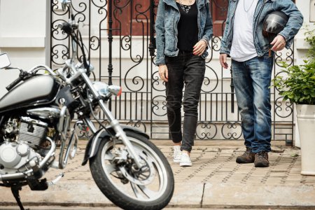 Photo for Cropped image of couple in jeans and denim jackets walking towards motorcycle - Royalty Free Image