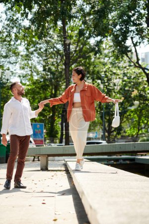 Photo for Happy young couple enjoying romantic date in park - Royalty Free Image