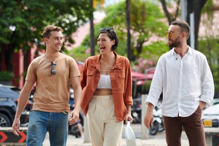 Photo for Happy excited adult friends walking around city - Royalty Free Image