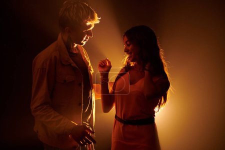 Photo for Cheerful young couple dancing in night club - Royalty Free Image