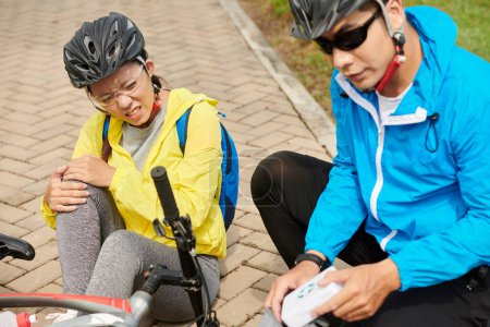 Foto de Mujer joven tiene lesiones en bicicleta cuando se cayó de la bicicleta de carretera mientras pedaleaba - Imagen libre de derechos