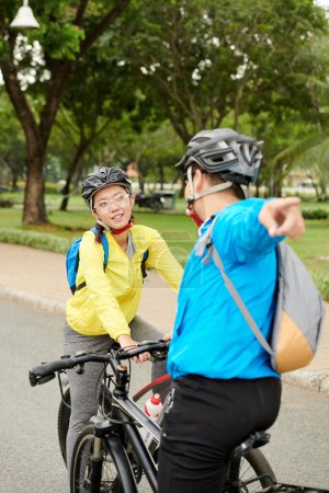 Photo for Friends deciding where to ride on bicycles - Royalty Free Image