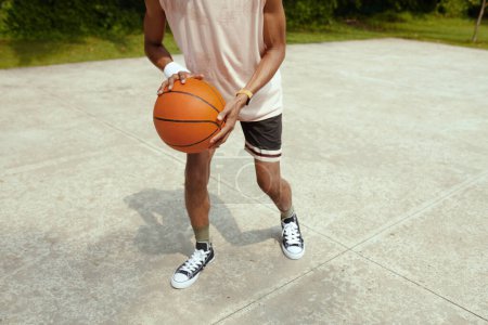 Photo for Cropped image of sweaty sportsman playing streetball on court - Royalty Free Image
