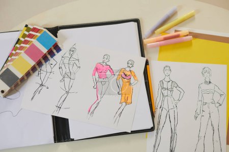 Photo for Fashion sketches, color palette and felt tip pens on desk of fashion designer - Royalty Free Image