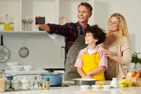 Photo for Happy family taking selfie in kicthen when cooking dinner together - Royalty Free Image
