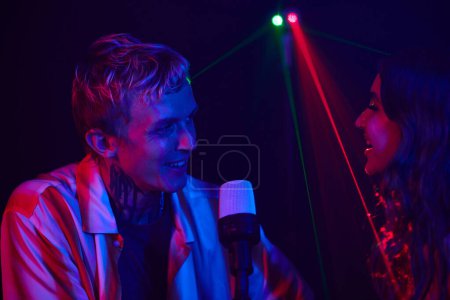 Photo for Happy couple enjoying singing in karaoke on fist date - Royalty Free Image