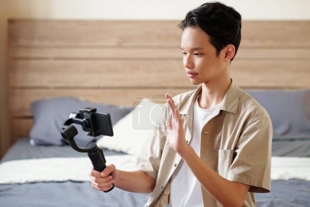 Photo for Kid recording himself on smartphone for his blog - Royalty Free Image