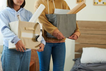 Photo for Cropped image of college students bringing their belongings in dormitory room - Royalty Free Image