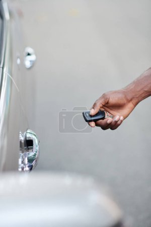 Photo for Hand of taxi driver using electronic key when opening car door - Royalty Free Image