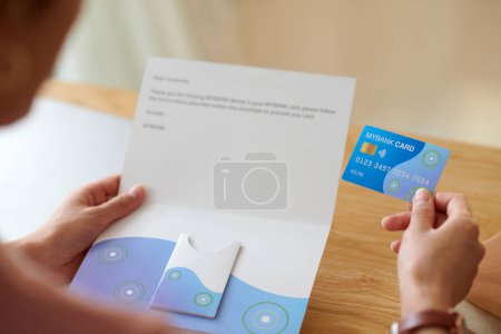 Photo for Woman reading letter from bank, containing credit card and personal loan offer information - Royalty Free Image