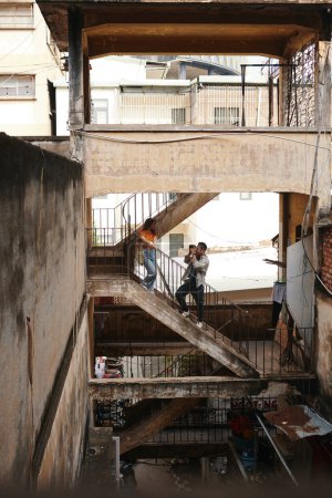 Photo for Coupe photographing on staircase of shabby building in old town area - Royalty Free Image