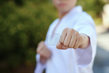 Photo for Taekwondo athlete doing jab punch when training outdoor - Royalty Free Image