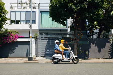 Photo for Woman using motorbike taxi service to get to office - Royalty Free Image