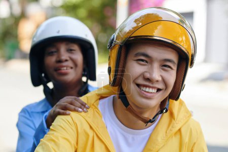 Photo for Portrait of smiling Vietnamese motorbike driver and happy passenger - Royalty Free Image