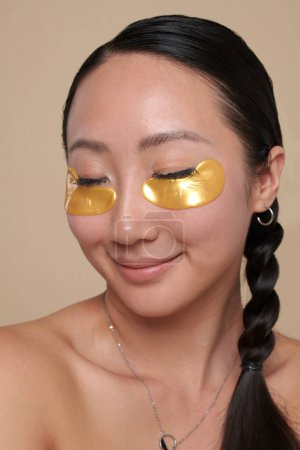 Photo for Portrait of smiling young woman with hydrogel undereye patches - Royalty Free Image