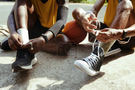 Photo for Black men wearing sports shoes for playing streetball - Royalty Free Image