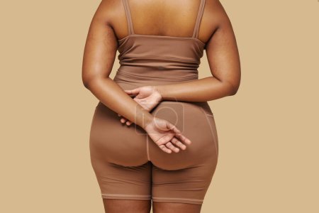 Rear view of curvy Black woman wearing shapewear