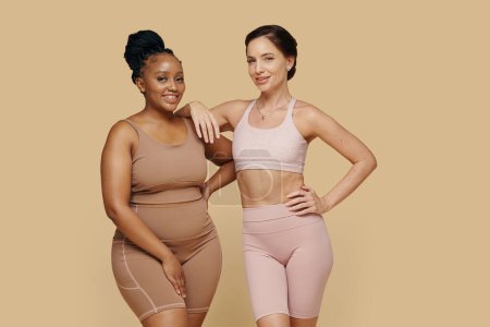 Happy women with different body types standing next to each other