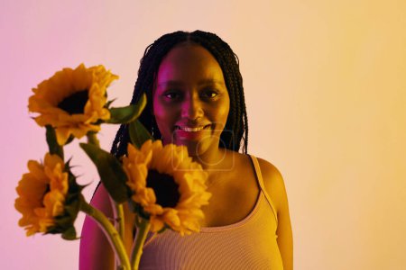 Photo for Happy Black woman accepting sunflowers from date - Royalty Free Image