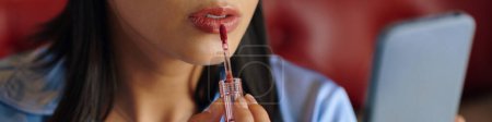 Photo for Header with woman applying red liquid lipstick - Royalty Free Image