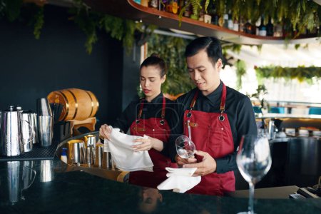 Photo for Bartender and waiter preparing restaurant for opening - Royalty Free Image