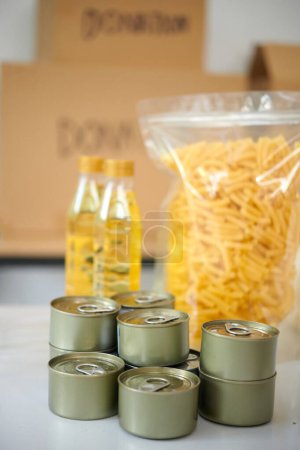 Photo for Canned food, big package of macaroni and vegetable oil prepared for donation - Royalty Free Image
