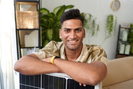 Photo for Portrait of happy man leaning on solar panel he bought - Royalty Free Image