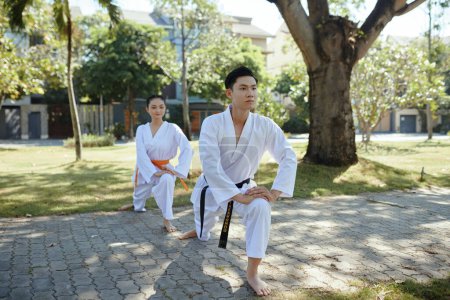Photo for Taekwondo athletes warming up and training outdoors - Royalty Free Image