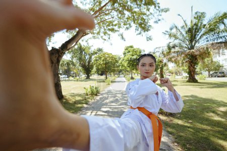 Photo for Taekwondo athlete in dobok kicking camera - Royalty Free Image