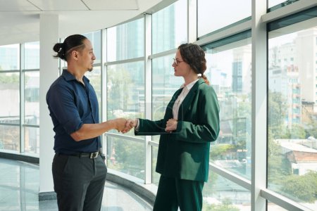 Photo for Business woman shaking hand of coworker from another department - Royalty Free Image