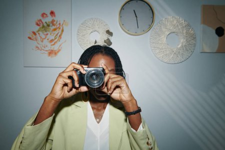 Photo for Portrait of Black woman taking photos with small camera - Royalty Free Image