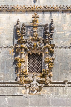 Photo for Tomar Portugal - 08 09 2022: Detailed view at the portuguese gothic ornamented window, manueline facade, with ornamented details, iconic chapterhouse window, on Cloister of Saint Barbara, Convent of Christ, Tomar - Royalty Free Image