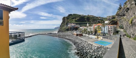Photo for Madeira Island Portugal - 04 21 2023: Panoramic view of Ponta do Sol beach, a small touristic village in the city of Funchal, main avenue facing the sea, with buildings, Madeira Island, Portugal - Royalty Free Image