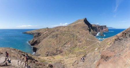 Photo for Madeira Island Portugal - 04 19 2023: Amazing panoramic view at the huge natural island cliffs, St. Lourenco Cape or Cabo de Sao Lourenco, group of tourists hiking, on Madeira Island, Portugal - Royalty Free Image