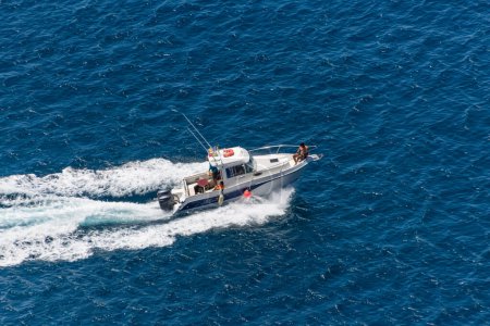 Foto de Isla de Madeira Portugal - 04 19 2023: Vista aérea de un barco recreativo privado con gente navegando, barco de caza en el océano Atlántico, costa en la isla de Madeira - Imagen libre de derechos
