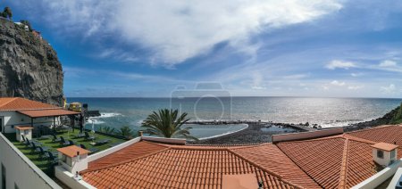 Photo for Madeira Island Portugal - 04 21 2023: Panoramic view of Ponta do Sol beach, a small touristic village in the city of Funchal, roof buildings and small bay facing the sea, in Madeira Island, Portugal - Royalty Free Image