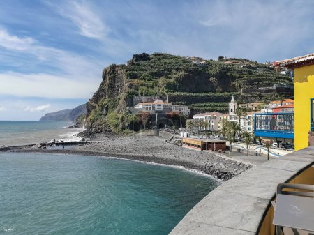 Photo for Madeira Island Portugal - 04 21 2023: View of Ponta do Sol, a small touristic village in the city of Funchal, main avenue facing the sea, with residential buildings, Madeira Island, Portugal - Royalty Free Image