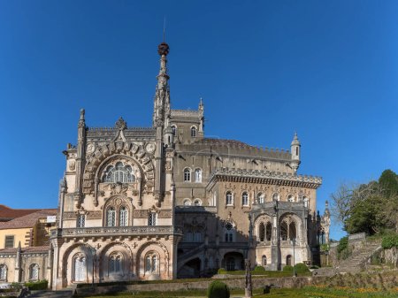 Photo for Luso / Aveiro / Portugal - 03 09 2019 : Full view of the back facade of the Bussaco Palace, Romantic palace in Neo-Manueline style monument, romantic classic gardens and blue sky, in Portugal - Royalty Free Image